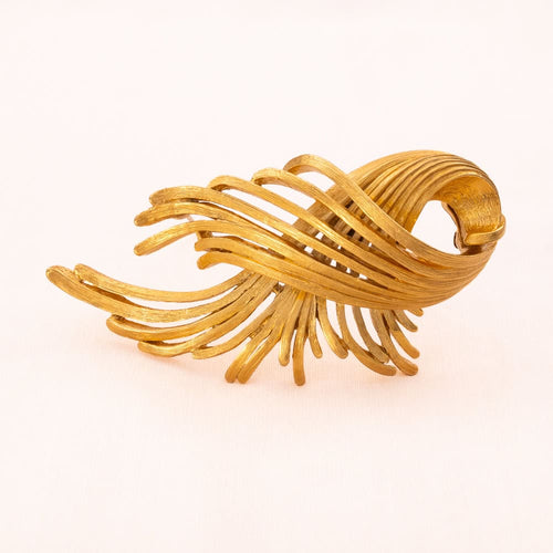 MONET gold-plated brooch in elegant curved shape