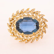 NINA RICCI Brosche mit blauem Kristall in Rankenfassung