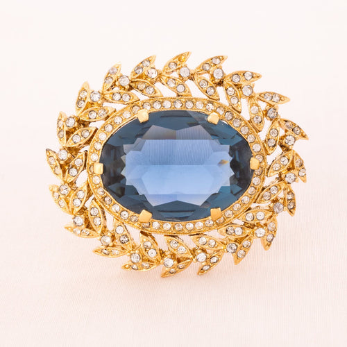 NINA RICCI brooch with blue crystal in a tendril setting