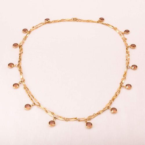Long necklace with beige colored crystals