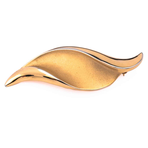 Large gold-colored vintage brooch by TRIFARI in a wave shape