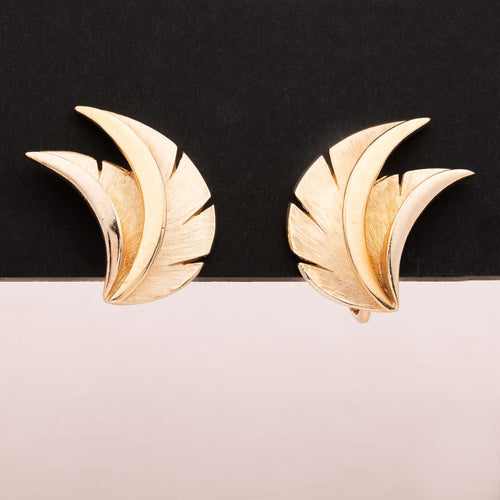 Gold colored leaf clip earrings by TRIFARI
