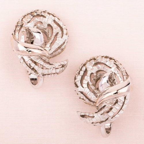 Silver-colored paisley design ear clips by TRIFARI