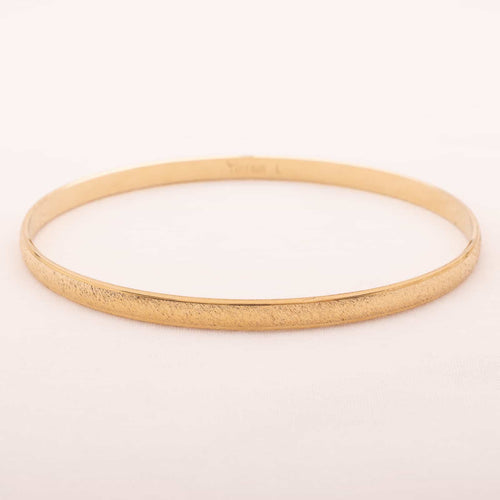 Gold plated bangle by TRIFARI from the 60s